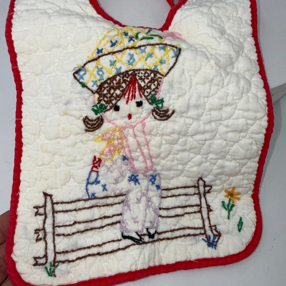 Vtg handmade quilted baby bib embroidered girl in a hat sitting on a fence